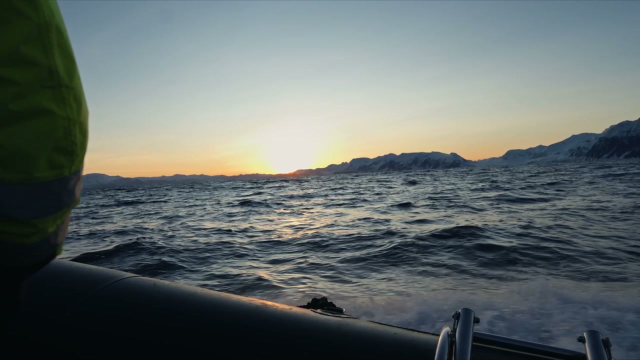 RIB Boat Navigating Arctic Waters at Sunset