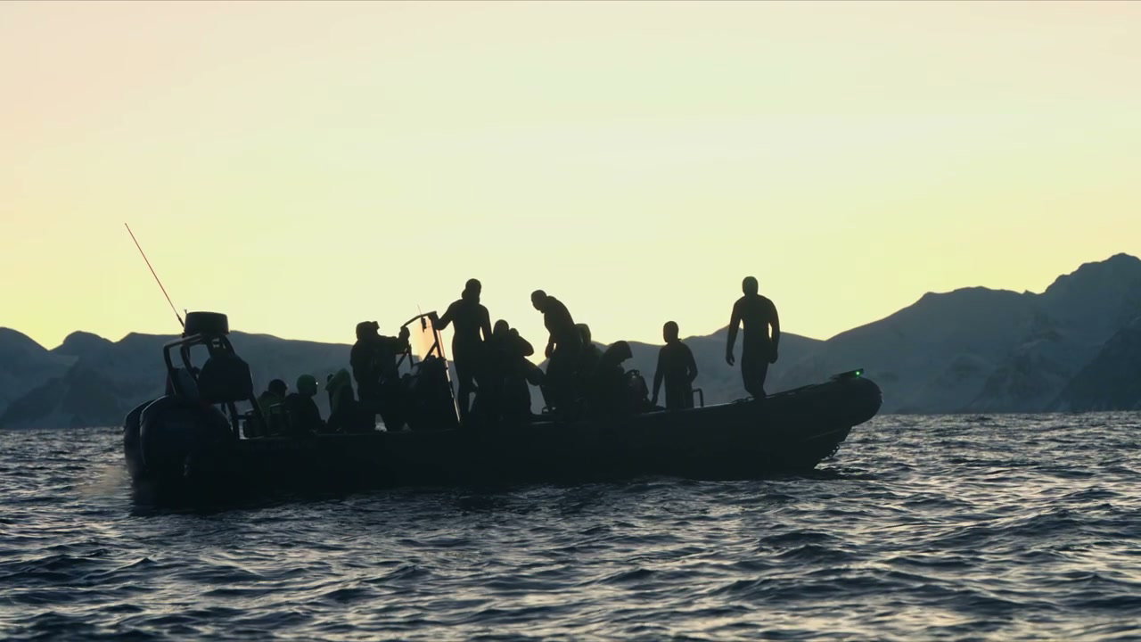 People in Boat at Sunrise in Arctic Norway
