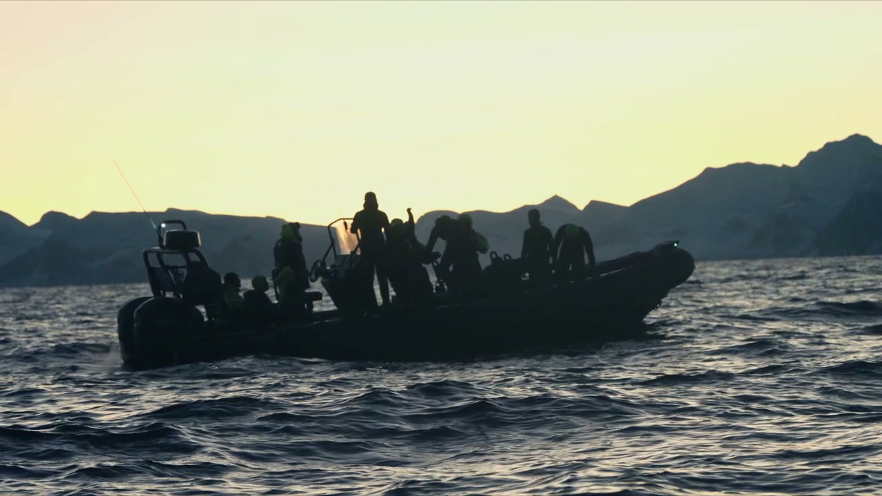 Arctic Boat Tour Against Mountain Sunset