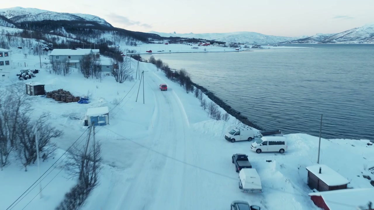 Red Vehicle on Snowy Coastal Road, Norway