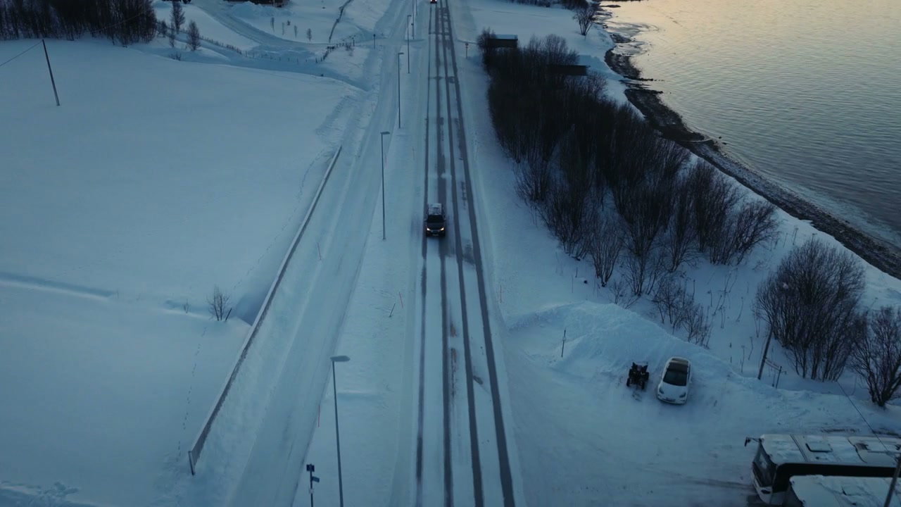 Car Driving on Snowy Arctic Road