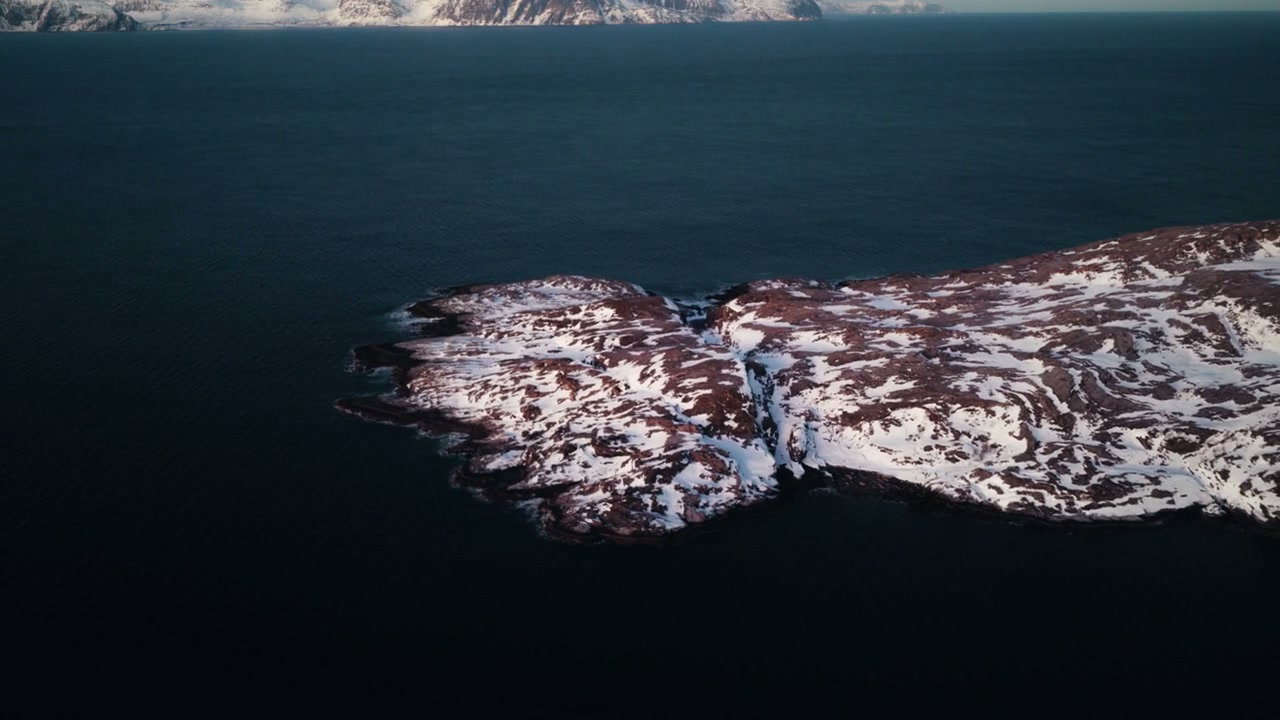 Aerial View of Snowy Arctic Coastline in Norway