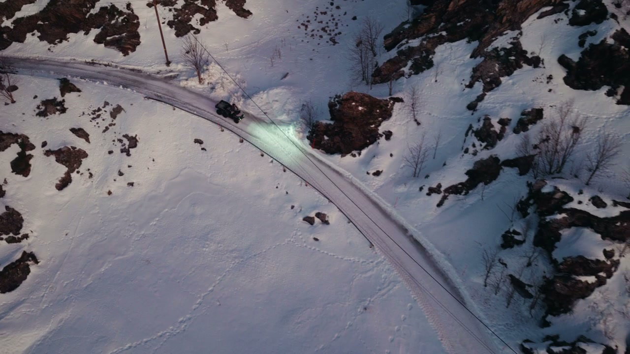 Car Driving Through Snowy Arctic Village