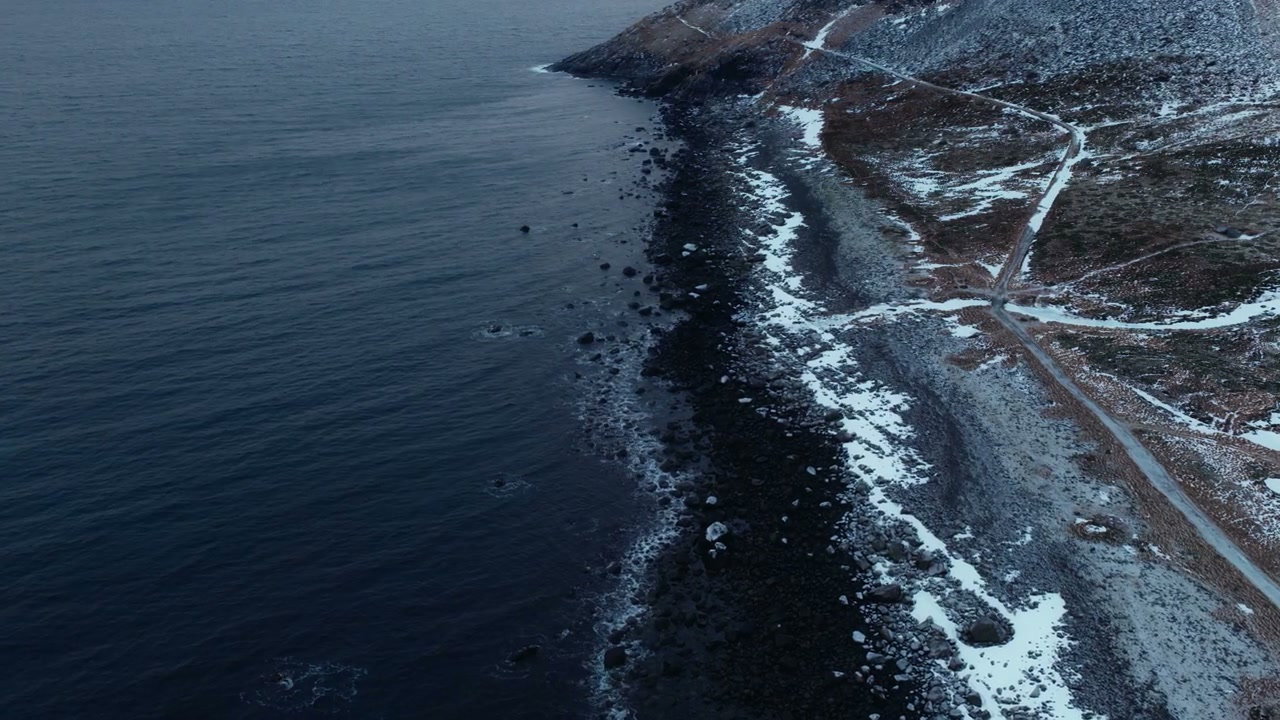 Arctic Ocean Waves on Snowy Norwegian Coast
