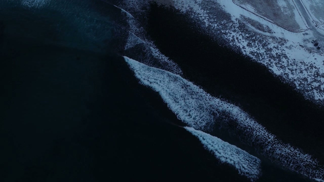 Winter Ocean Waves Breaking on Snowy Beach