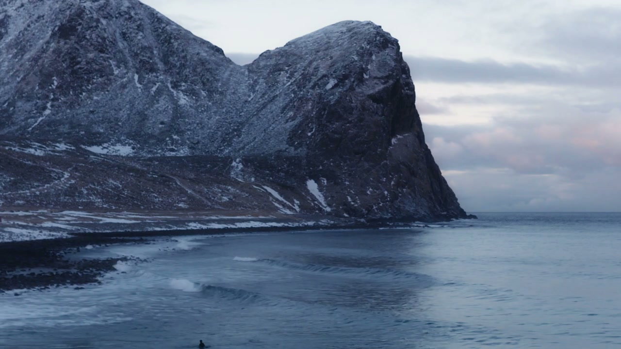 Surfer Paddling in Cold Norwegian Sea