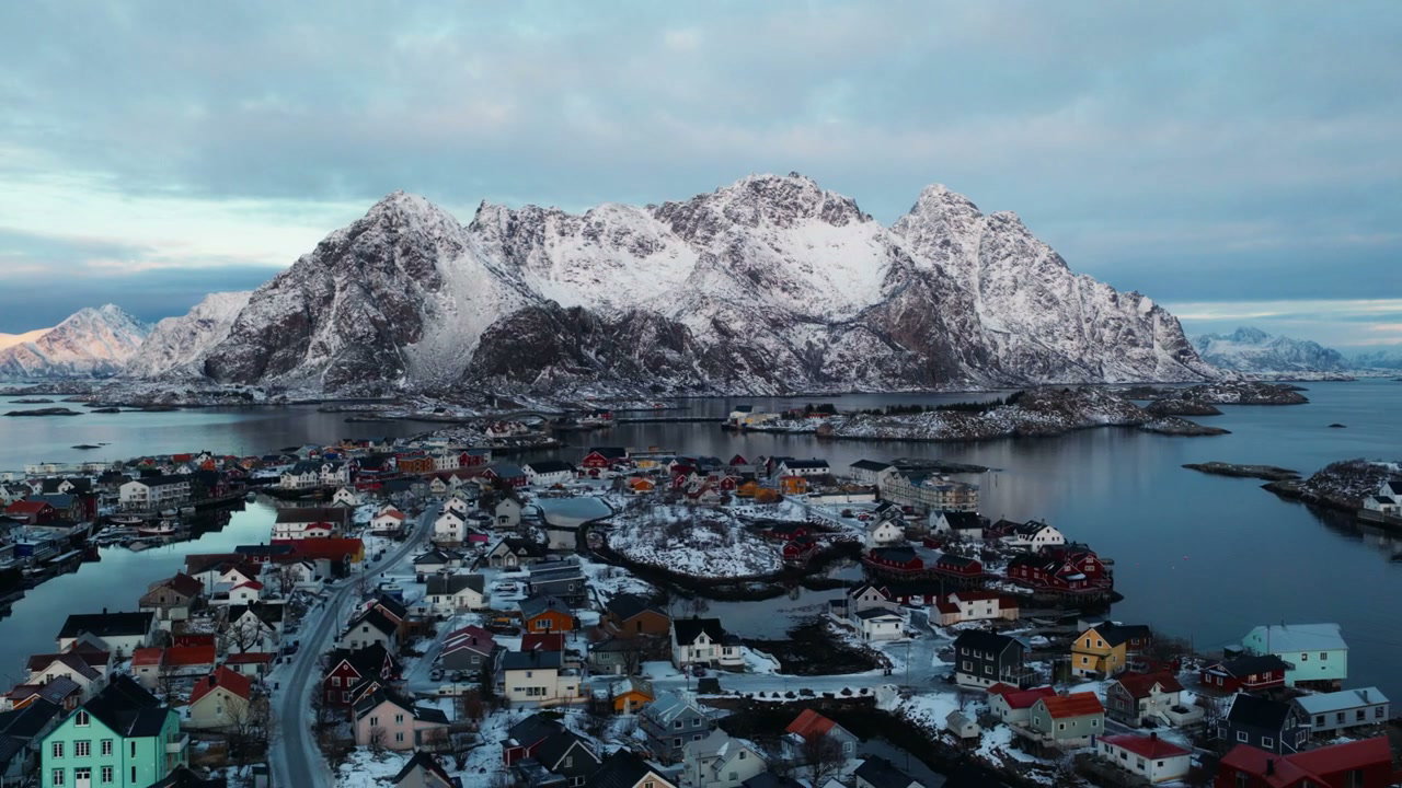 Snowy Norwegian Coastal Village and Mountains