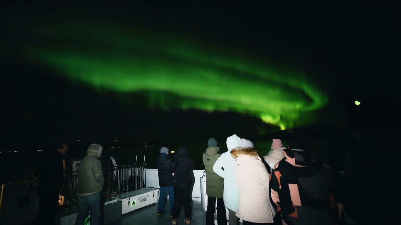 People Watching Northern Lights from Boat in Norway