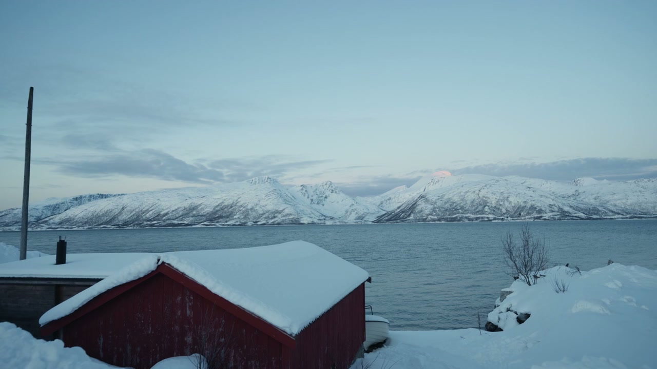 Snowy Arctic Fjord with Red Cabin