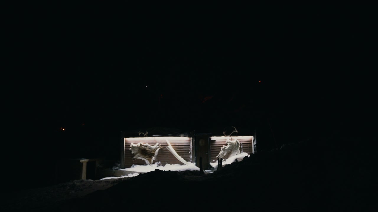 Illuminated Arctic Huts in Winter Night