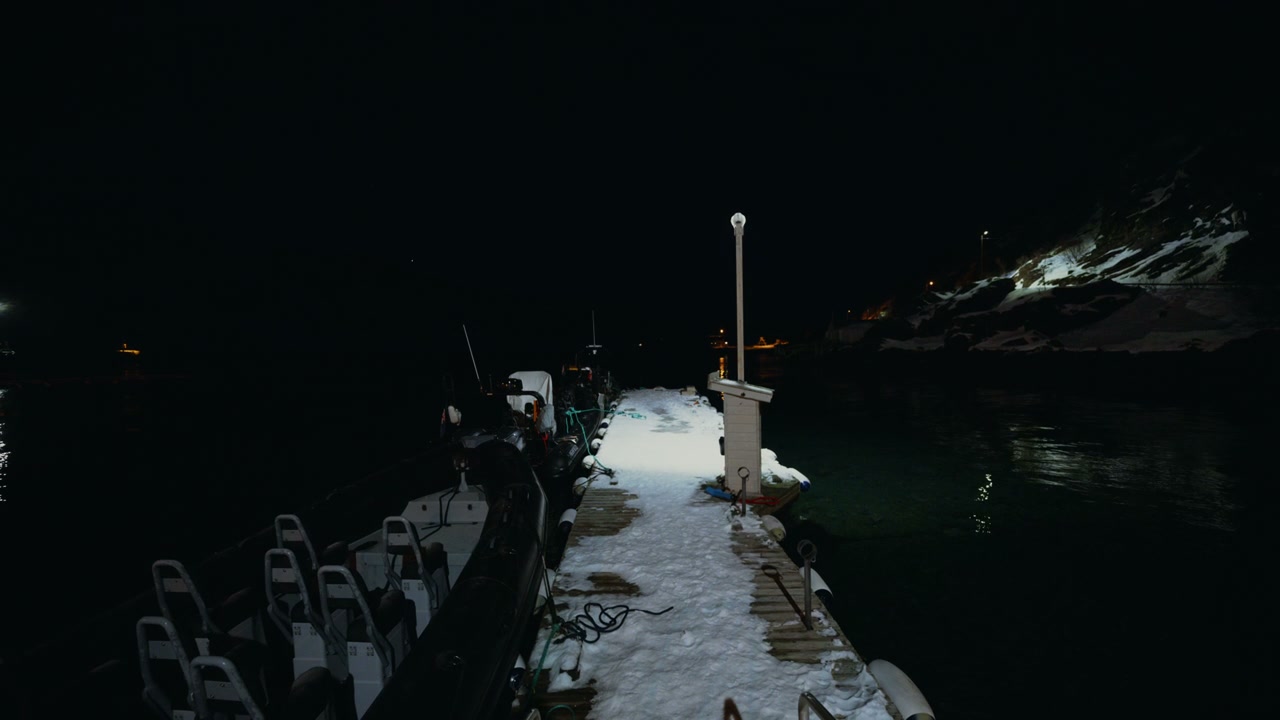 Snowy Pier With Boats at Night in Arctic Norway
