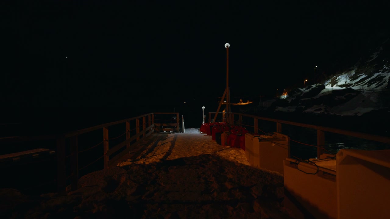 Snowy Pier and Sea at Night in Arctic Norway