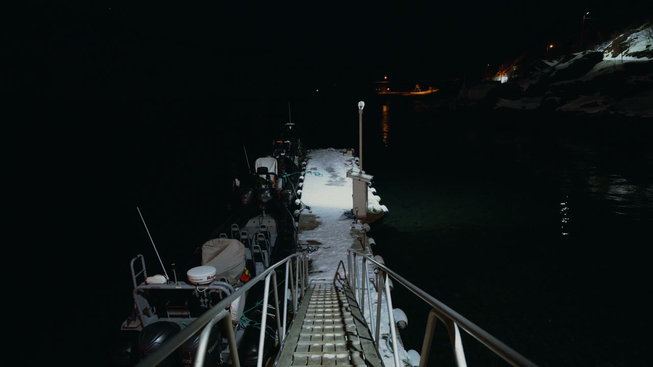 Snowy Pier and Moored Boats at Night in Norway