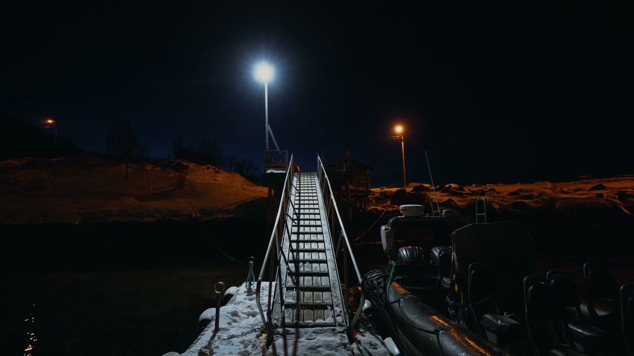 Snow-covered Pier and Boat at Night in Norway