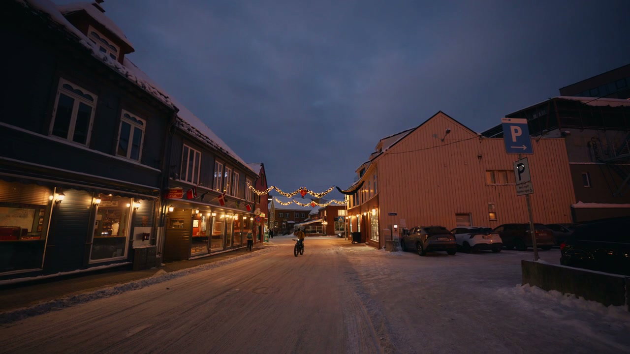Cyclist on Snowy Street in Arctic Norway