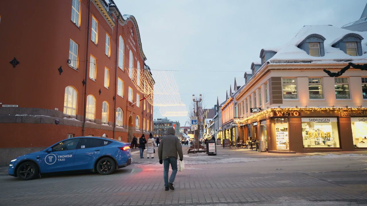 Person Walks on Snowy Tromso City Street