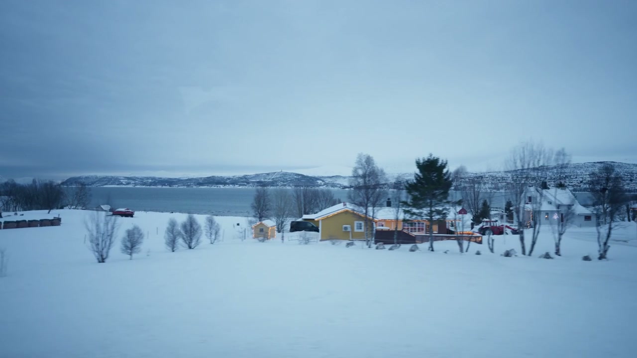 Snowy Village by Arctic Fjord in Norway