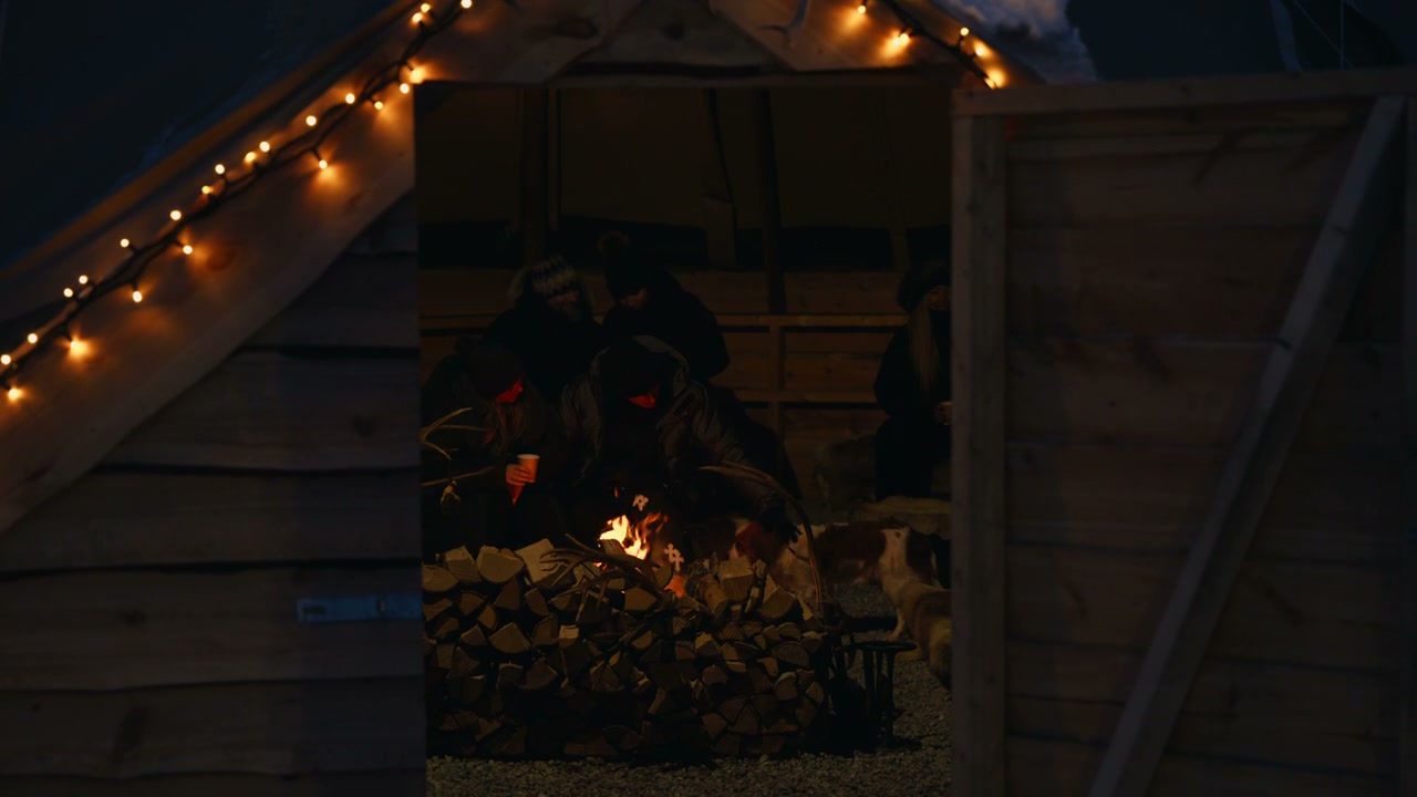Cozy Friends Gathering Around Campfire at Night