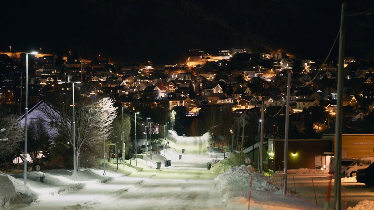 Snowy Street with Town Lights at Night