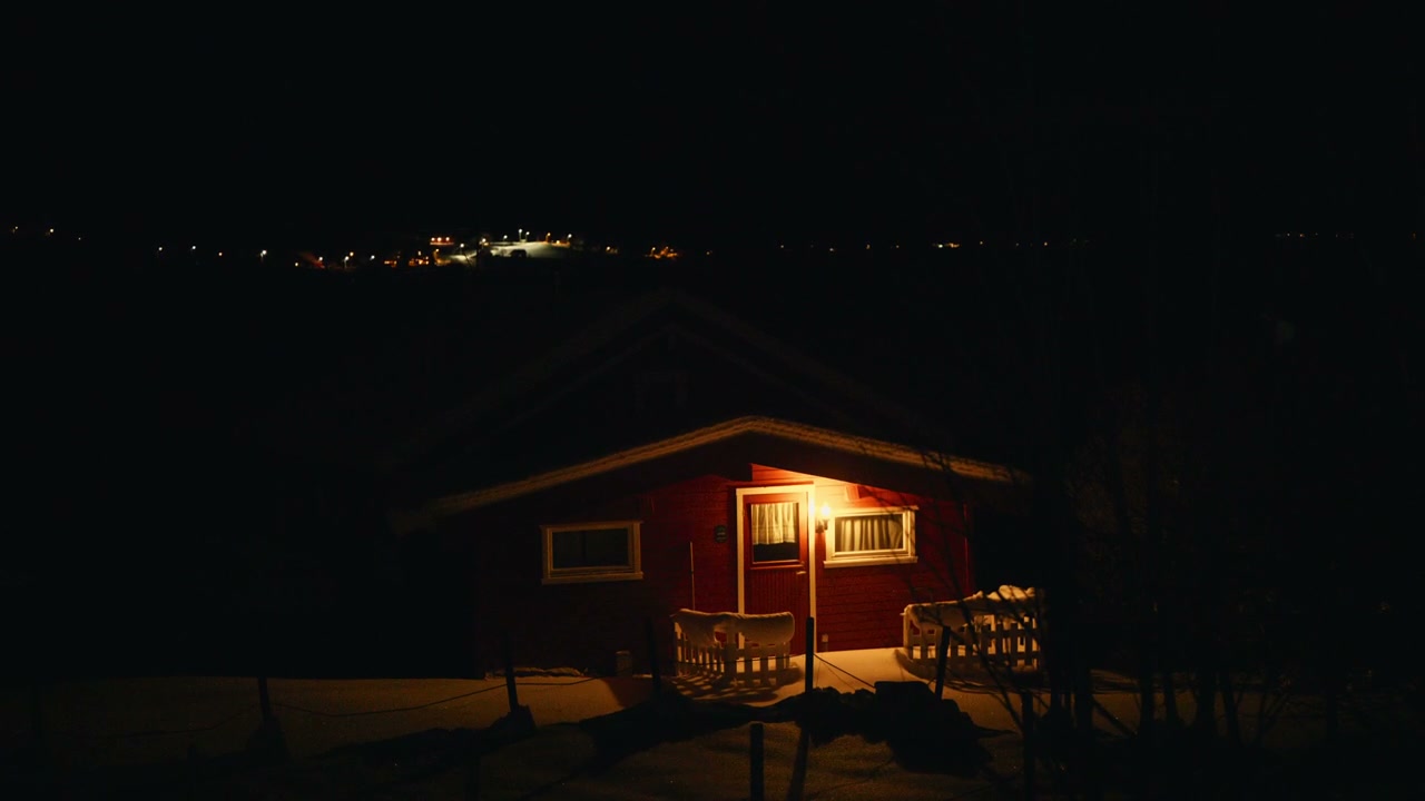 Illuminated Red Cabin in Winter Night