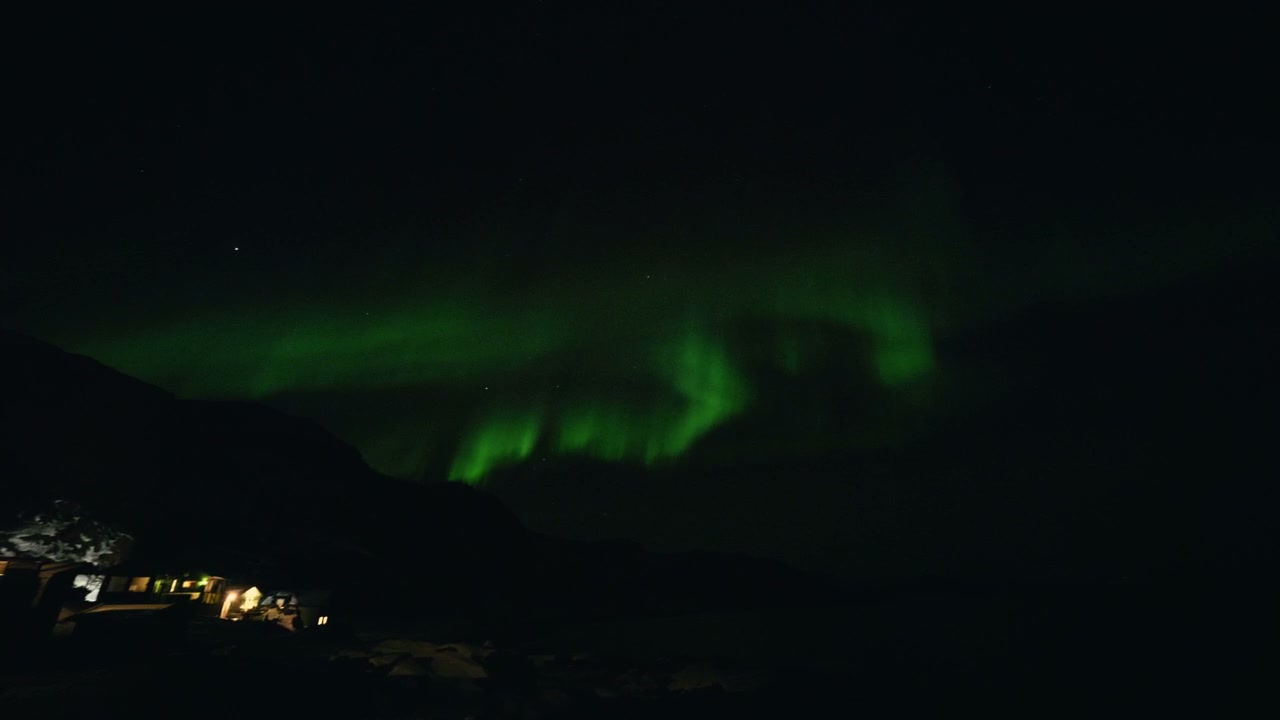 Dancing Northern Lights over Arctic Landscape