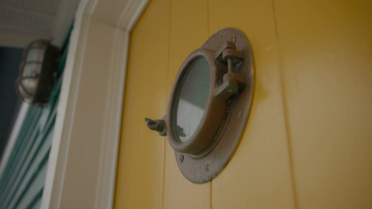 Nautical Porthole on a Yellow Floating Home