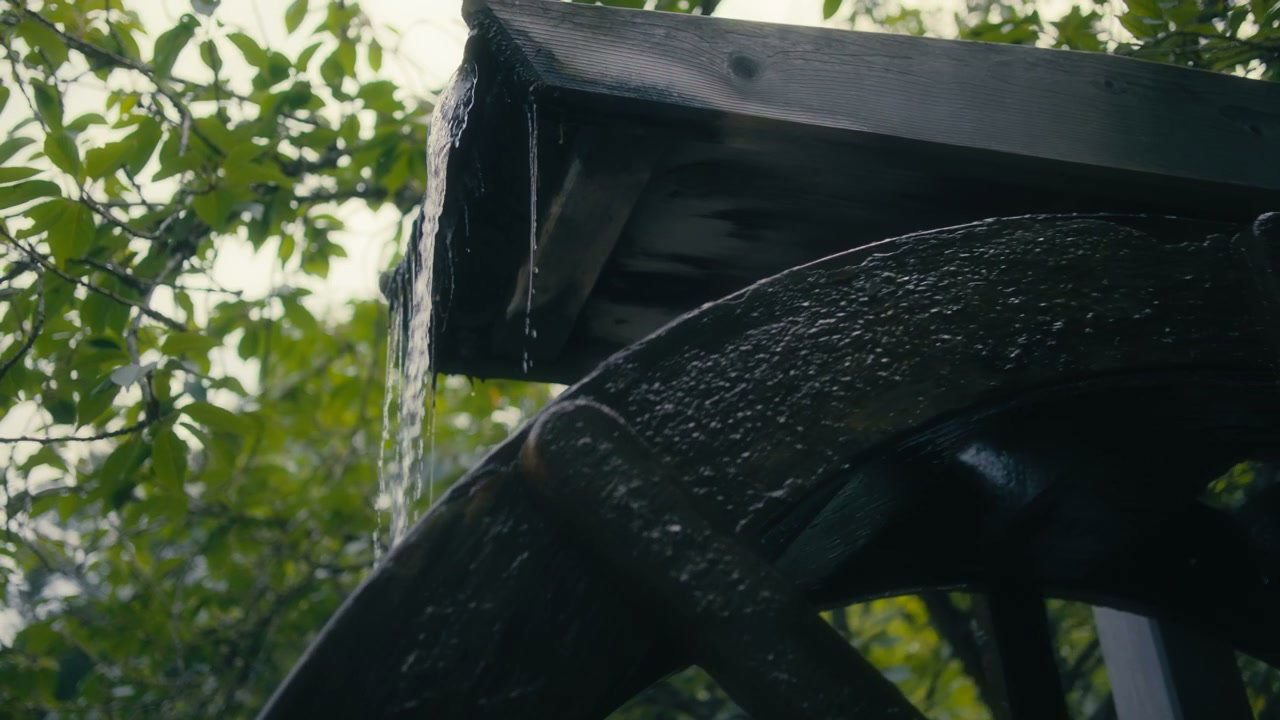 Water Falling on Rustic Wooden Water Mill Wheel