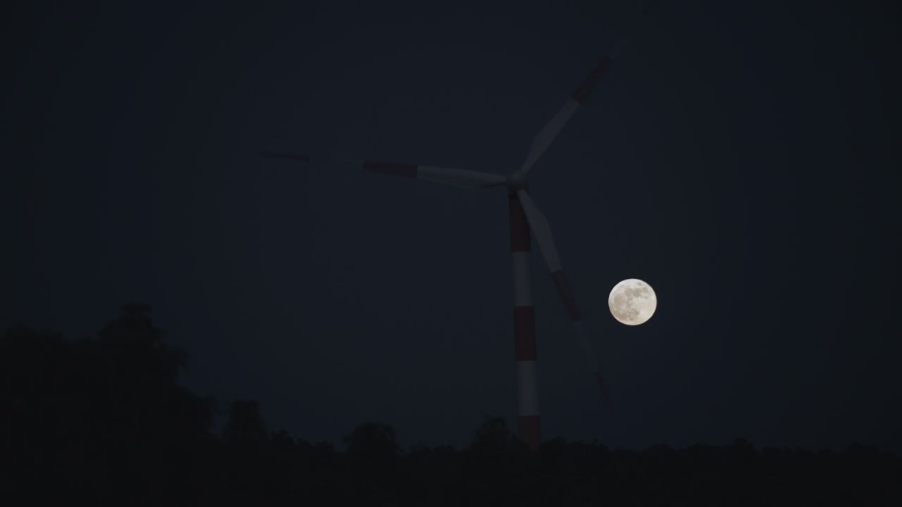 Moon Passing Behind Wind Turbine