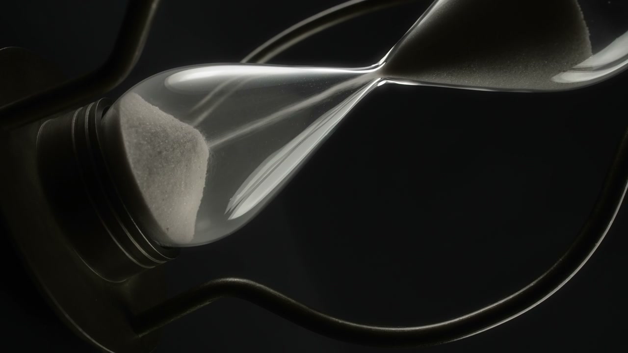 Hand Rotating Hourglass with Falling Sand • Stock Video on Uppbeat