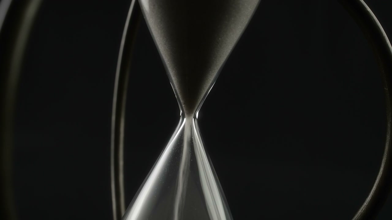 Hand Rotating Hourglass with Falling Sand • Stock Video on Uppbeat