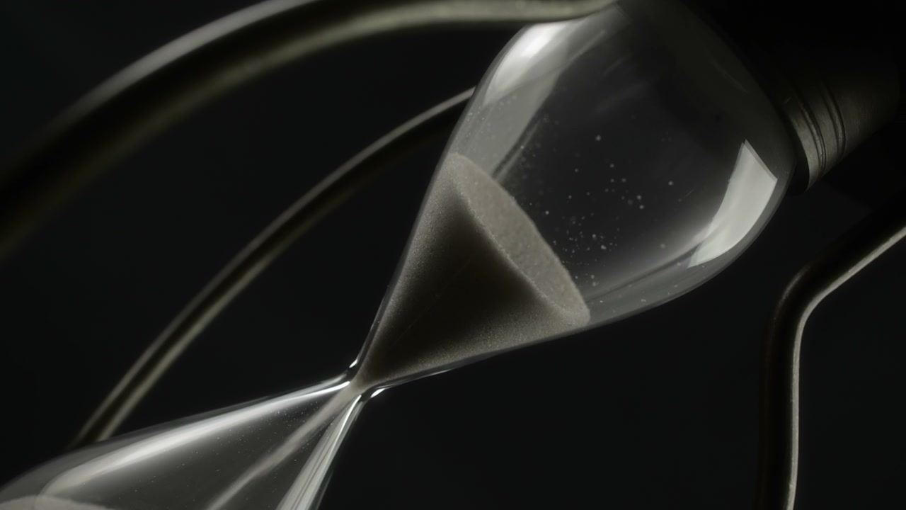 Hand Rotating Hourglass with Falling Sand • Stock Video on Uppbeat
