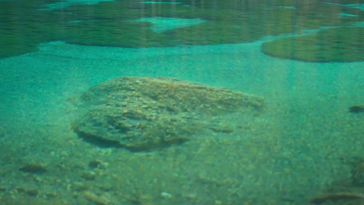 Clear Turquoise Water and Rocks in Grassi Lake