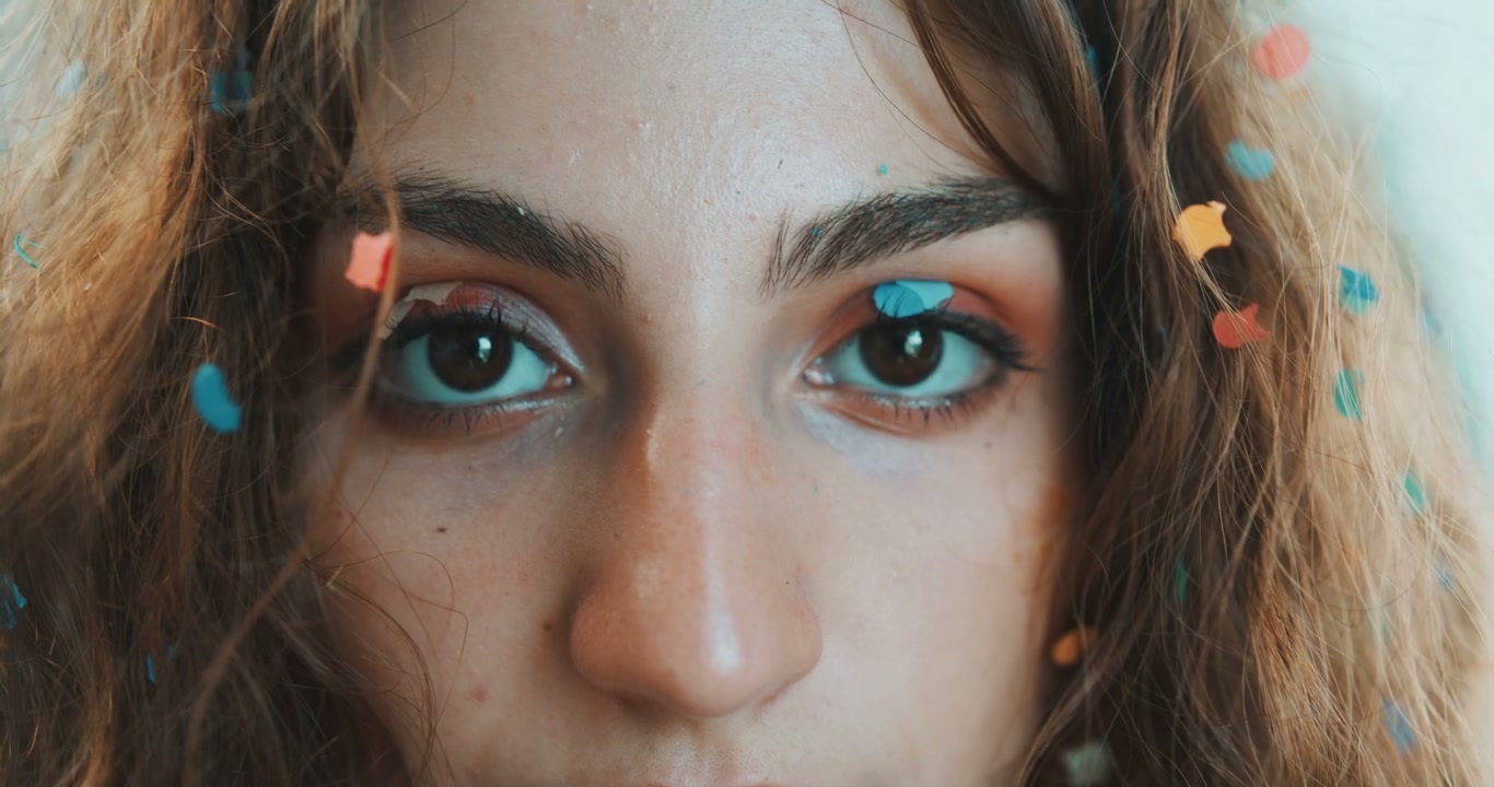 Person's Eyes Covered in Confetti