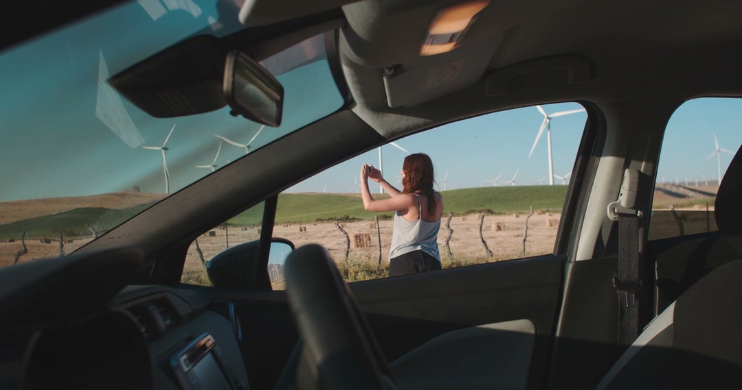 Man Gets Out of Car at Wind Farm • Stock Video on Uppbeat