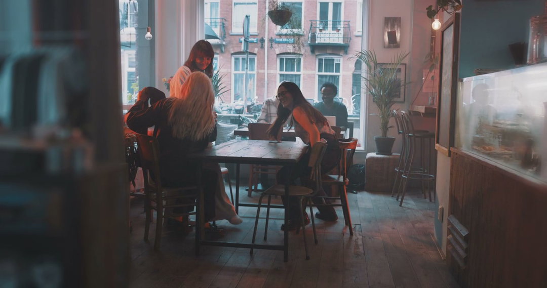 Friends Talking and Drinking Coffee in Cafe • Stock Video on Uppbeat