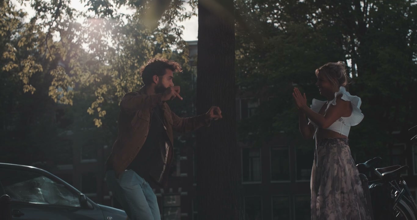 Man Hula Hooping with Woman Watching