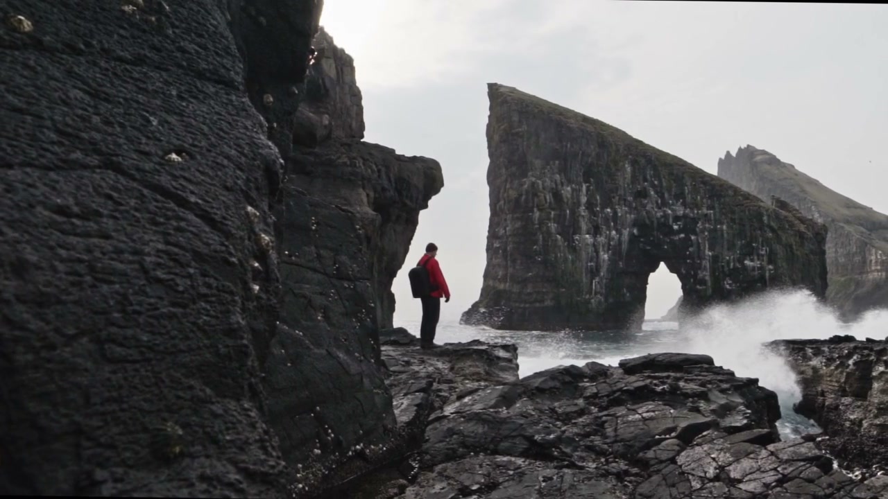 Hiker Overlooking Drangarnir Sea Stacks