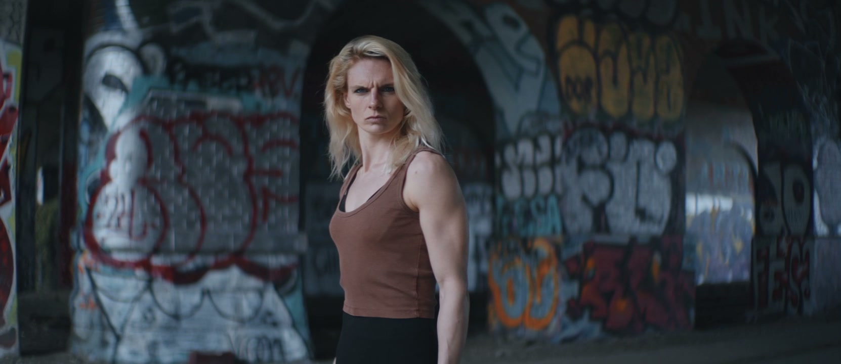 Intense Woman Under Graffiti Arches