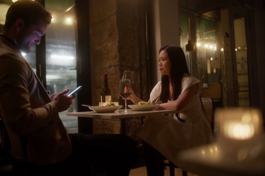 Distracted Man on Phone During Restaurant Date