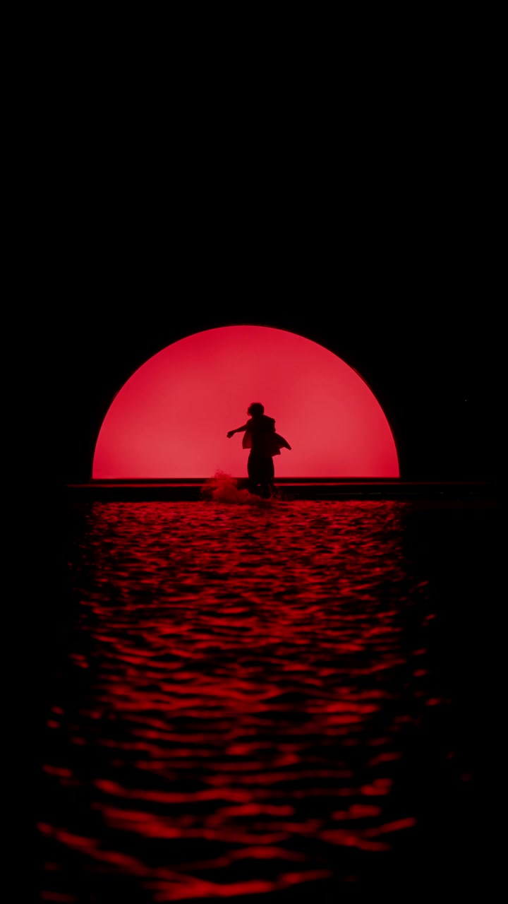 Dancer Silhouette in Red Water