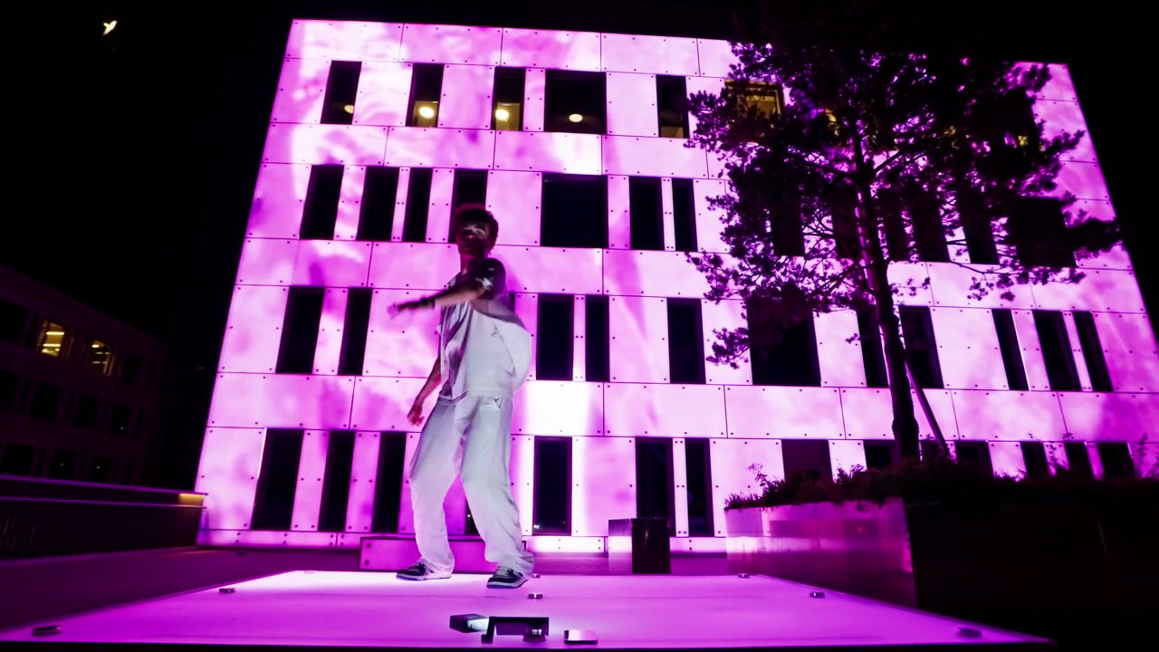Urban Dancer Performance with Pink Illuminated Building