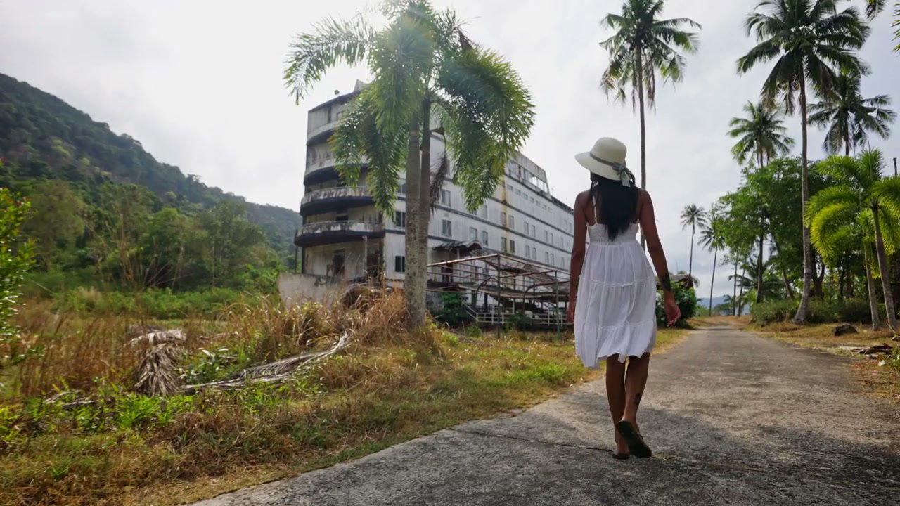 Woman Walks Away from Abandoned Resort Hotel