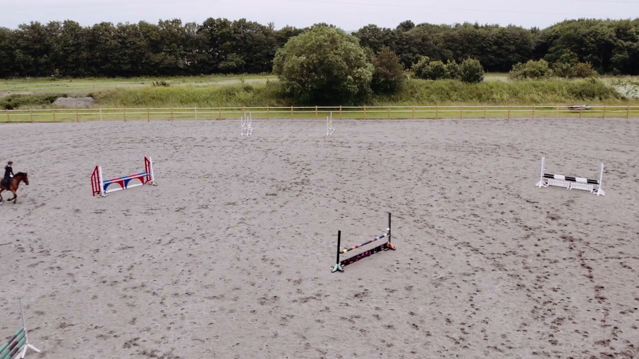 Horse and Rider Jumping in Indoor Equestrian Arena • Stock Video on Uppbeat