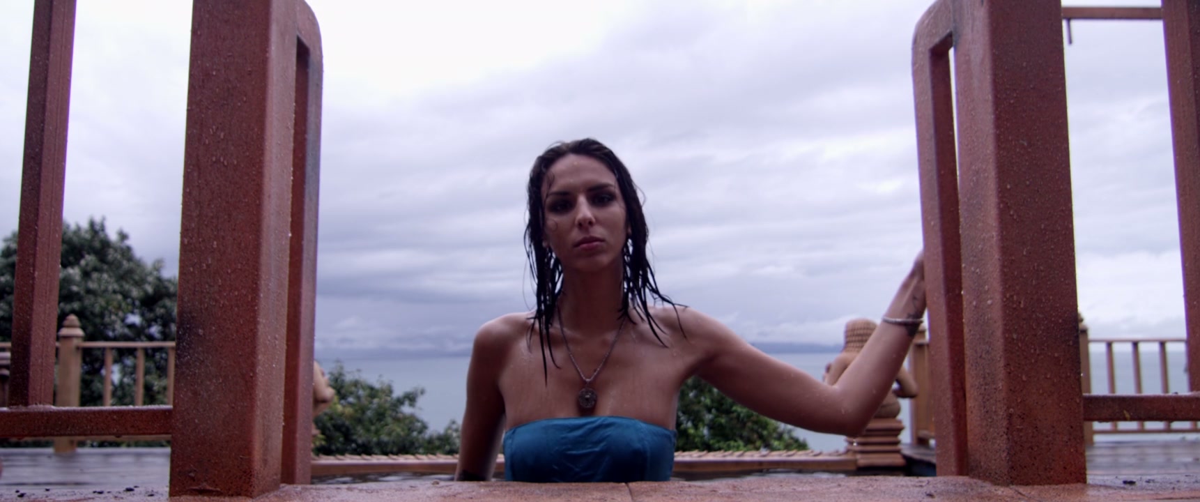 Woman Emerges From Pool at Temple in Thailand