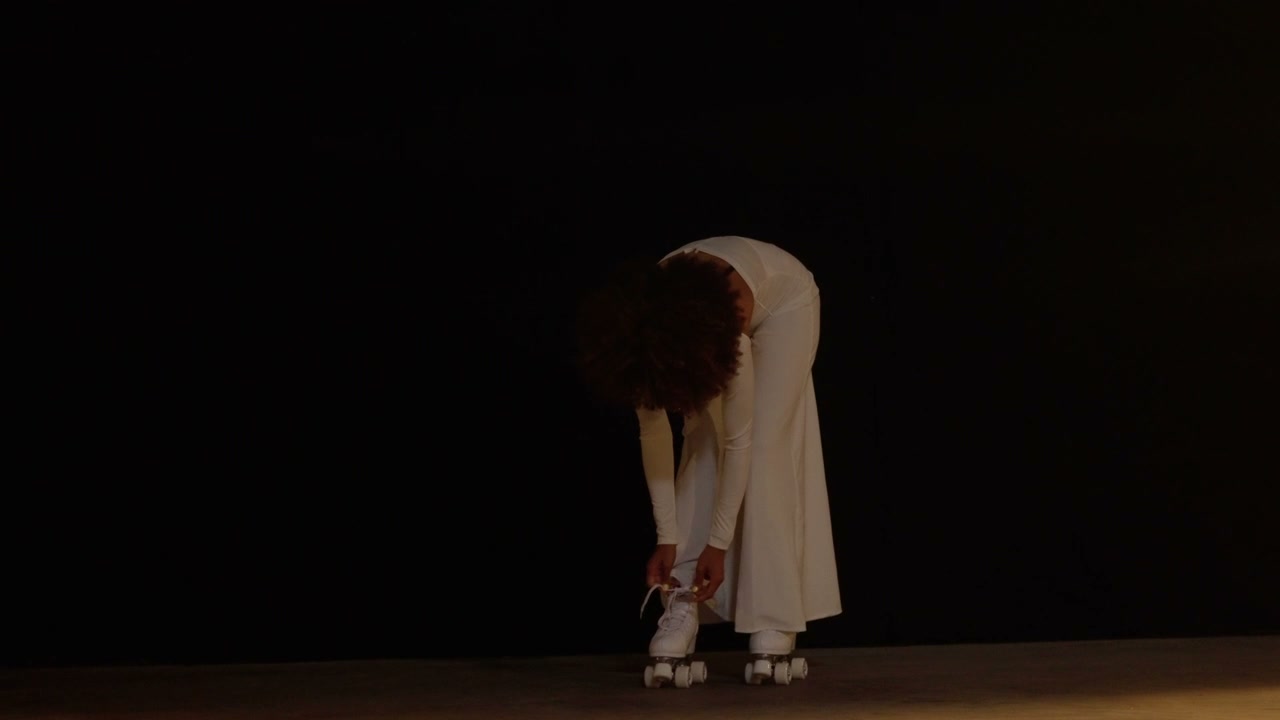 Person Tying White Roller Skate Laces