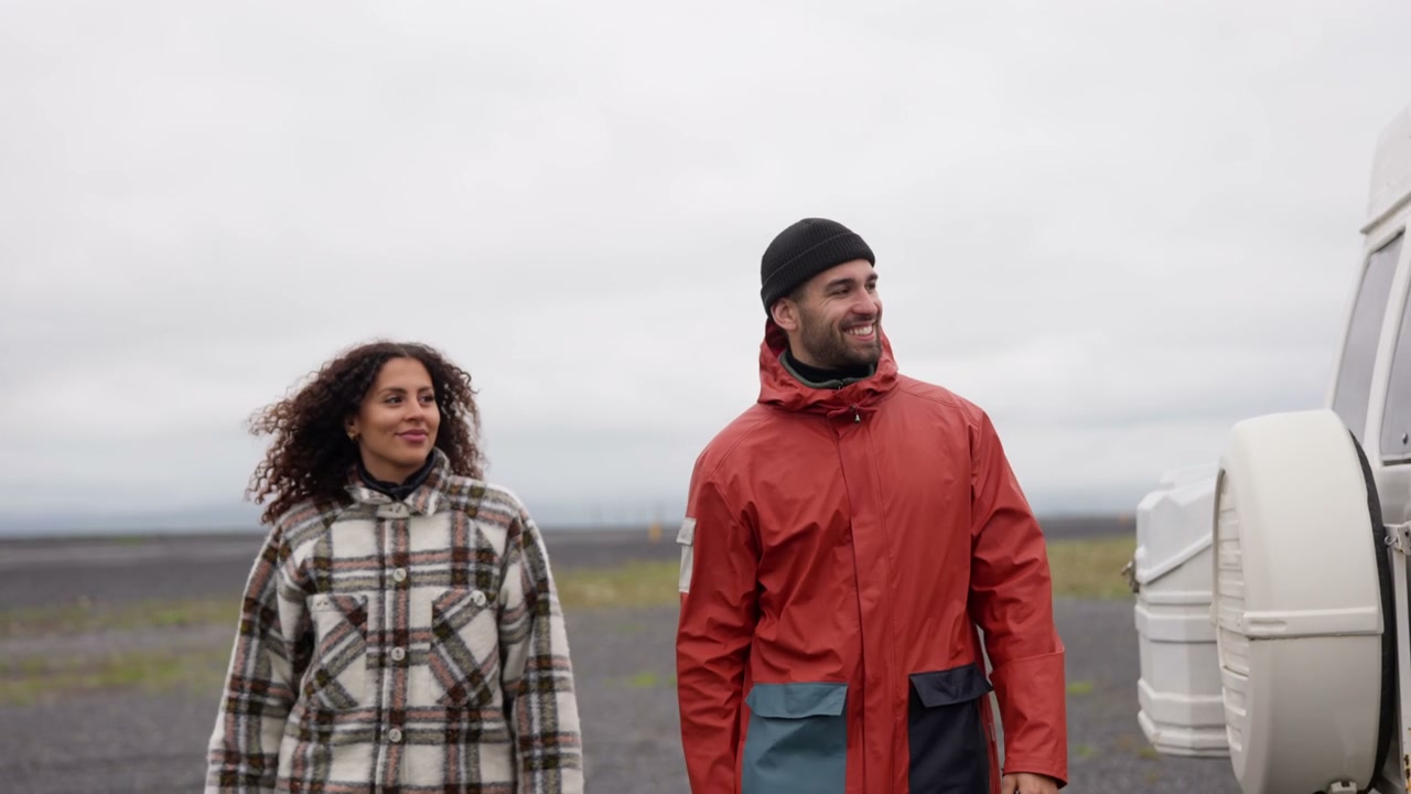 Smiling Couple Walking by Camper Van