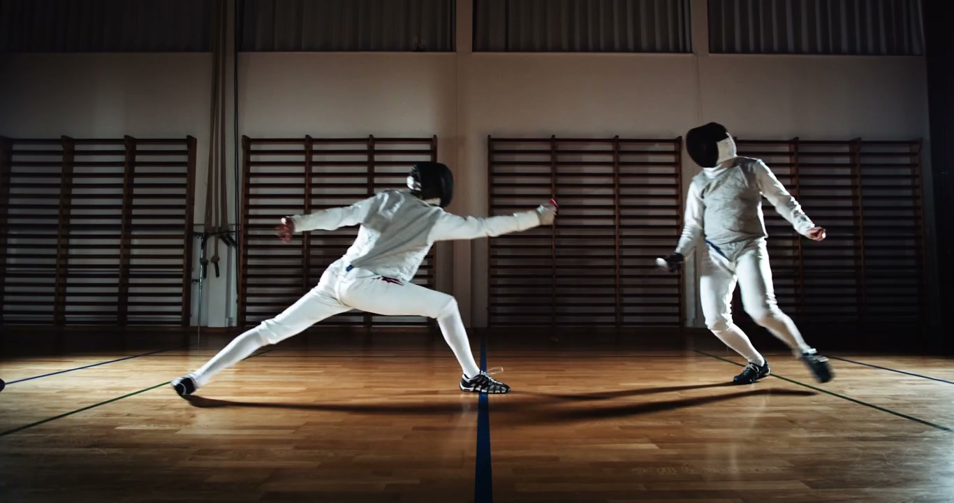 Fencers Dueling in a Gymnasium