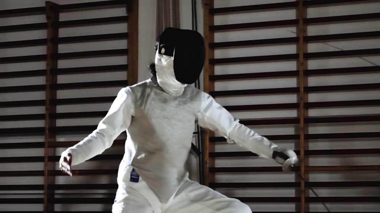 Fencers Dueling in Gymnasium