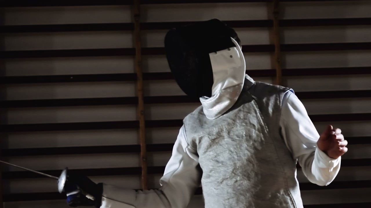 Fencers Duelling in a Gymnasium