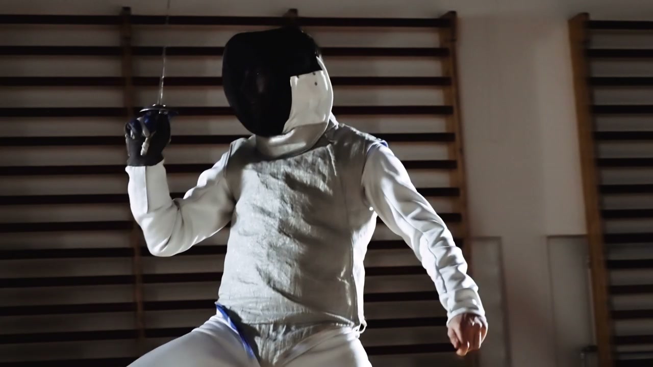 Fencer Practicing in Gymnasium